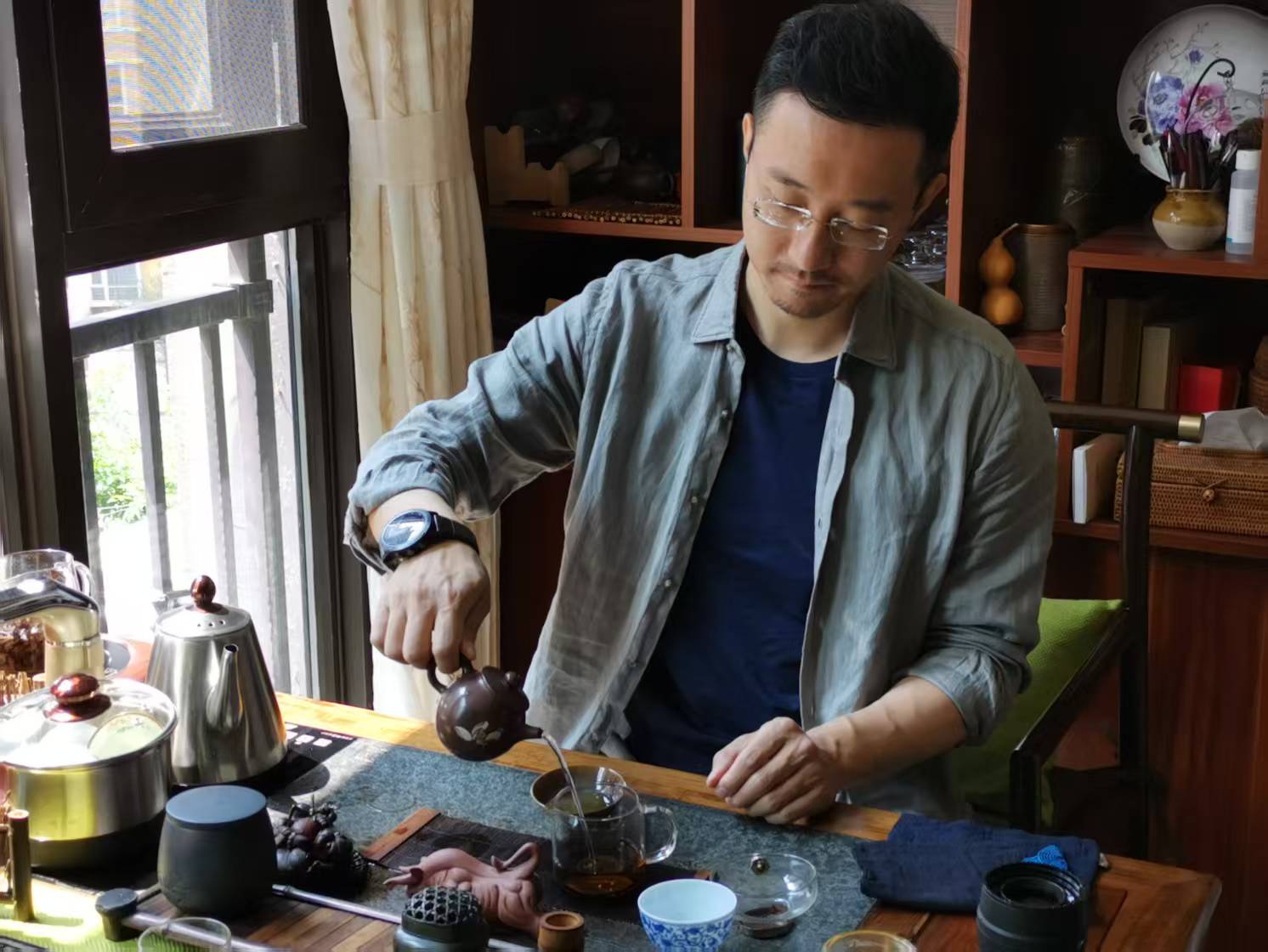 Founder brewing Pu-er tea with a small teapot